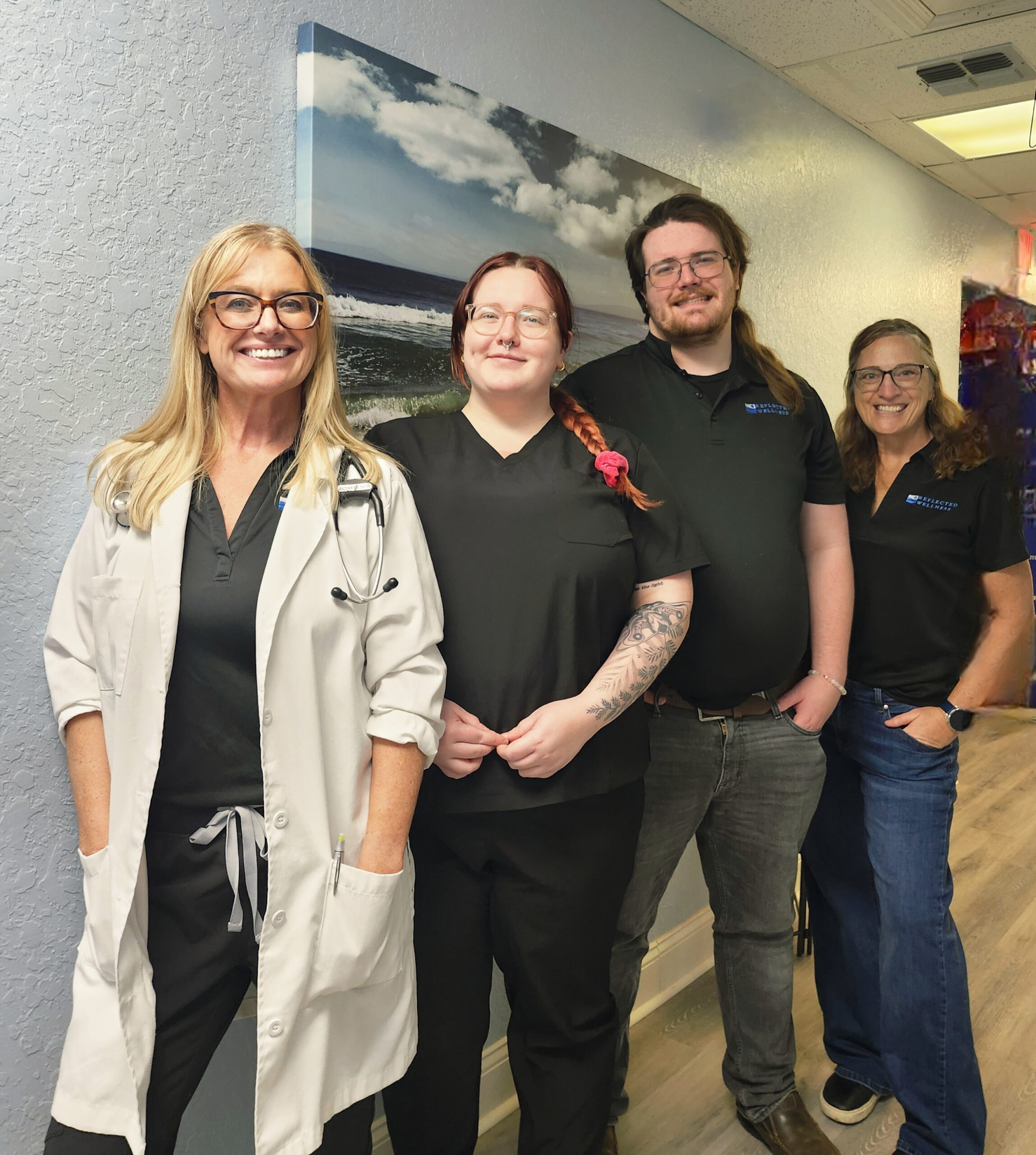 Reflected Wellness staff: three ladies and a man standing